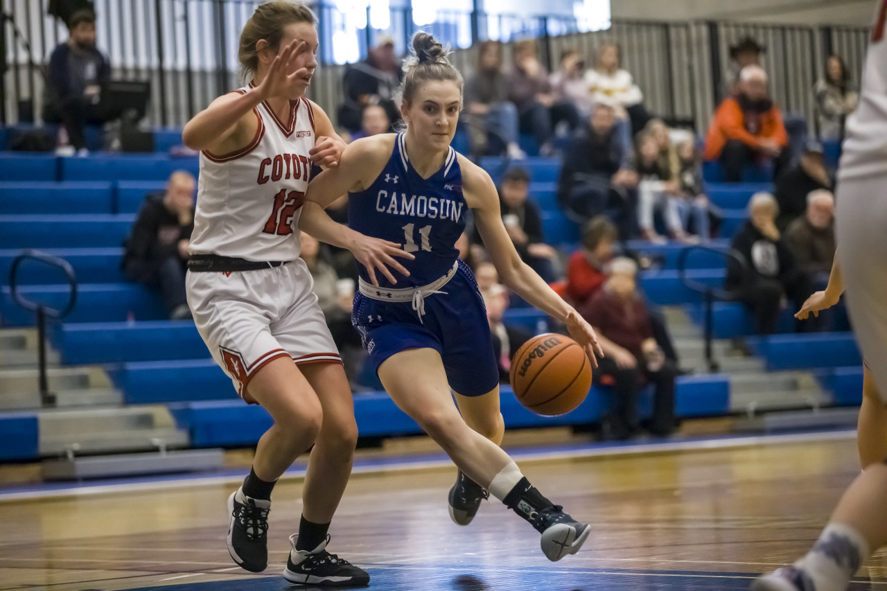 A Charger out dribbles her opponent on the basketball court 